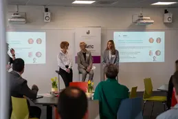 three women speaking as part of conference