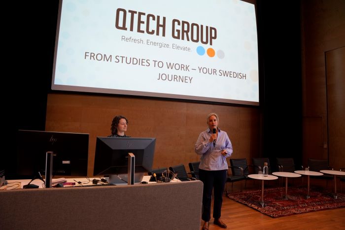 Woman presenting on a scene.