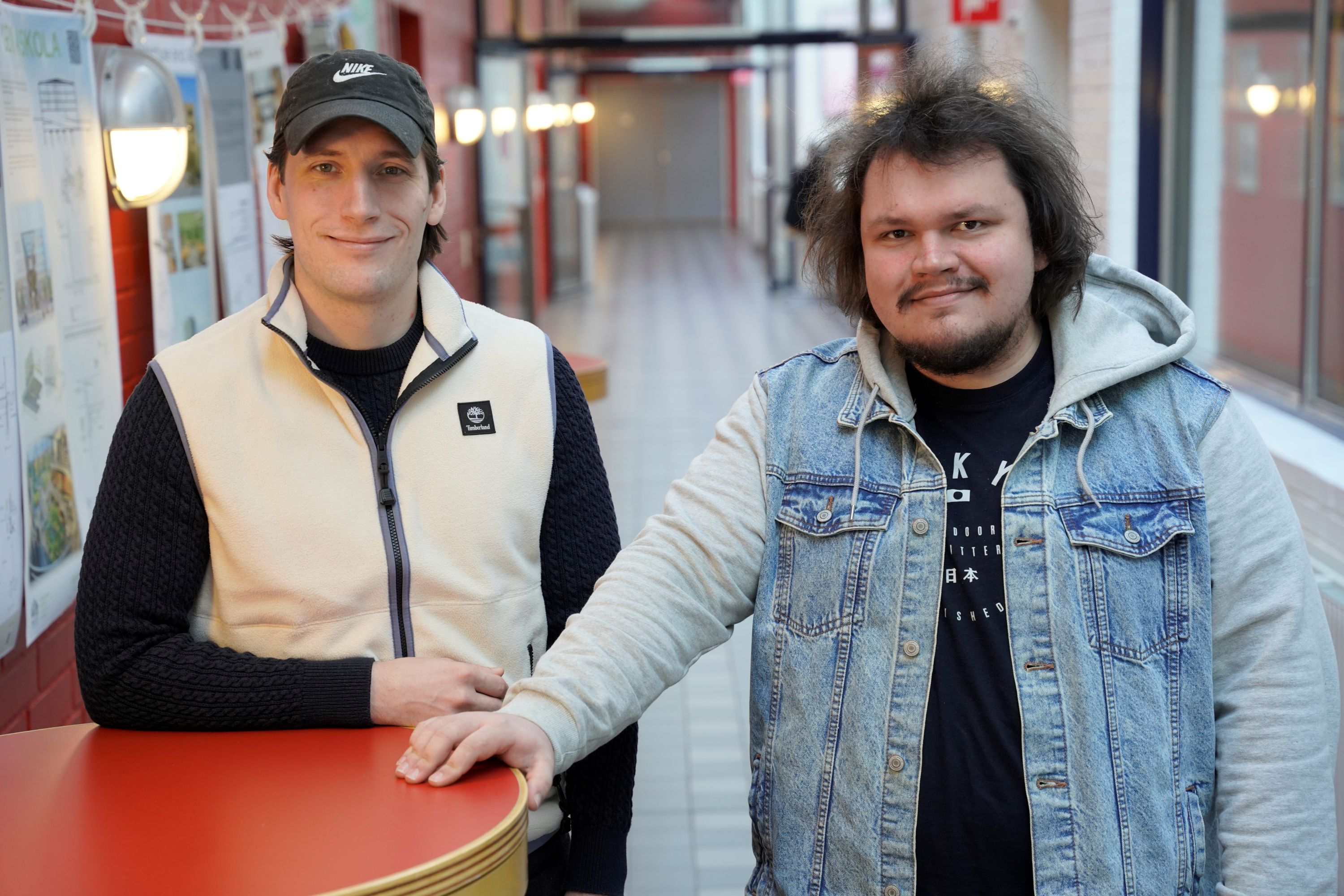 Two students in a school corridor.