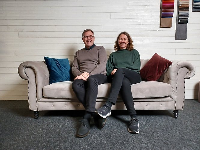 Man and woman sitting on a couch